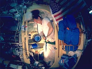 Norm Thagard zips sleep restraint in his sleep station in the Core Module of Russia's Mir Space Station. 